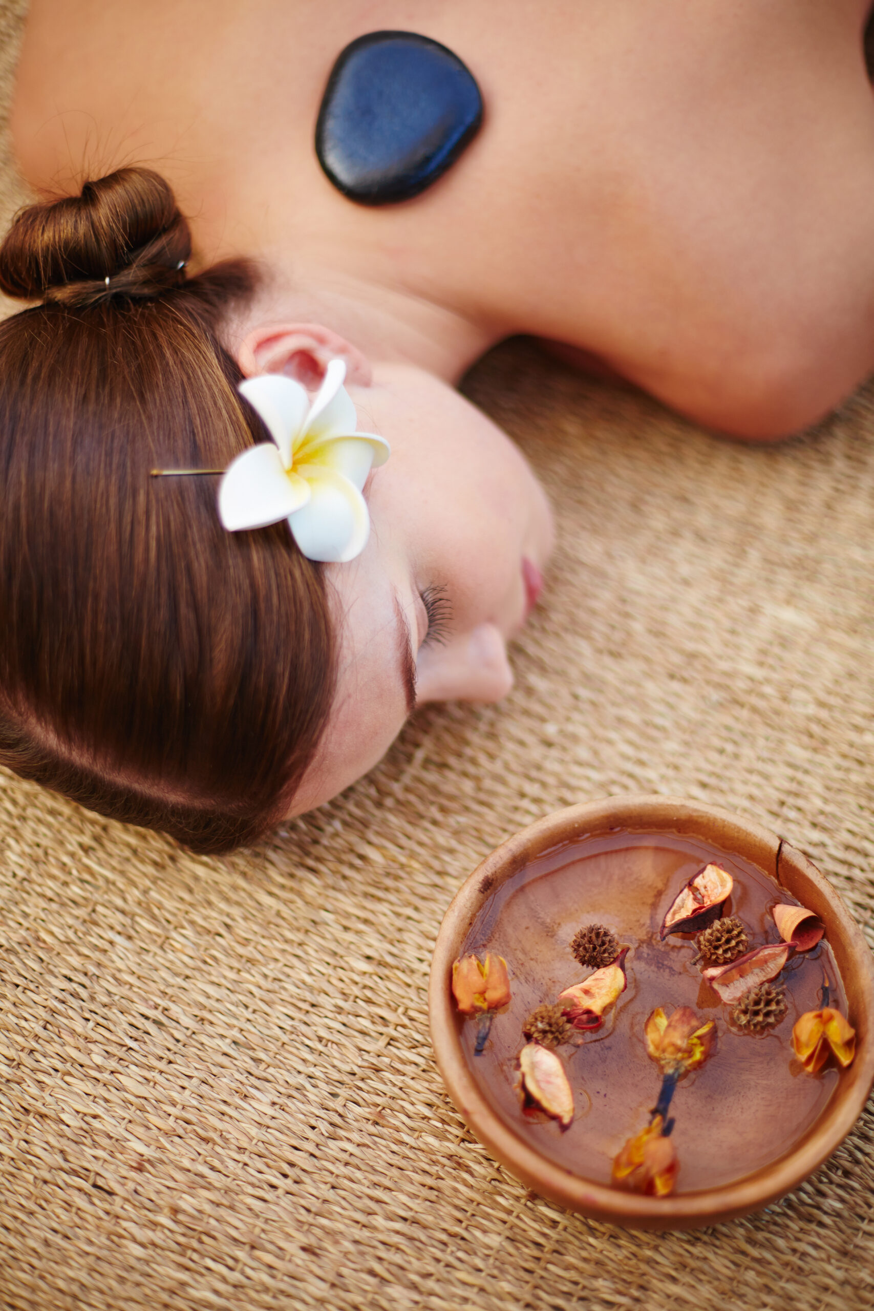 woman enjoying hot stone massage scaled.jpg